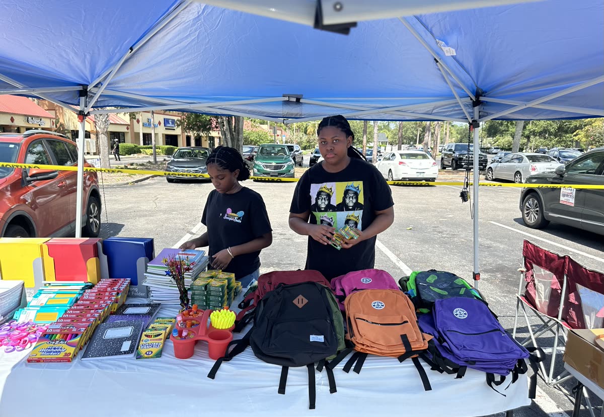 A table full of free backpacks, notebooks, folders, crayons, markers and school supplies at the Scoops & Subs back-to-school giveaway in Palm Coast