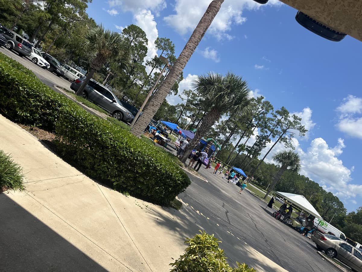 Neighbors gathered under the tents at the St. Joe Plaza Back to School Block Party in Palm Coast