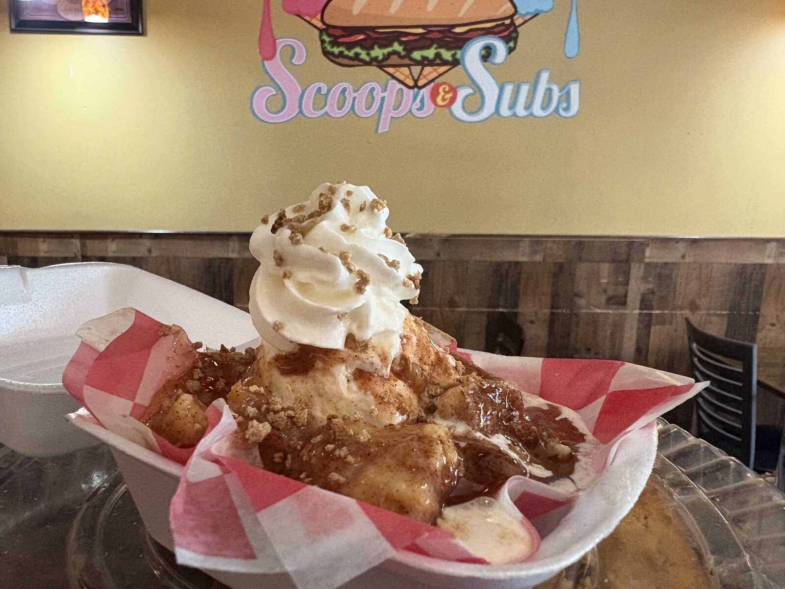 Warm apple dessert topped with whipped cream